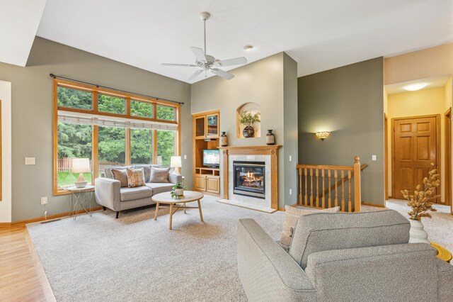 307 Lincoln Dr SE, Saint Michael, MN 55376 - living room featuring baseboards, a tile fireplace, a ceiling fan, wood finished floors, and a high ceiling