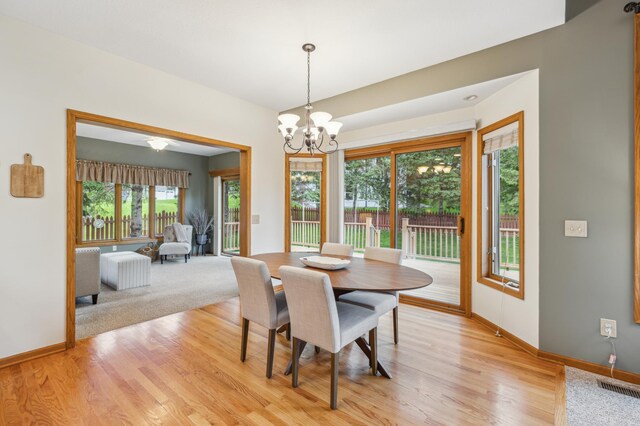 307 Lincoln Dr SE, Saint Michael, MN 55376 - dining space featuring a chandelier, baseboards, and light wood-type flooring