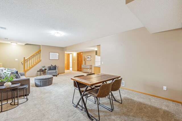 307 Lincoln Dr SE, Saint Michael, MN 55376 - dining space with stairs, light colored carpet, a textured ceiling, and baseboards
