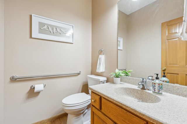 307 Lincoln Dr SE, Saint Michael, MN 55376 - bathroom with toilet, vanity, and wood finished floors