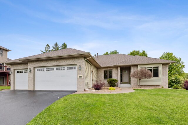 307 Lincoln Dr SE, Saint Michael, MN 55376 - view of front of house with brick siding, driveway, an attached garage, and a front lawn