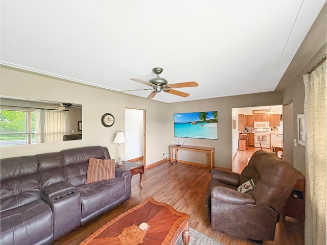 602 26th St, Scanlon, MN 55720 - living room with a ceiling fan, light wood-type flooring, and baseboards
