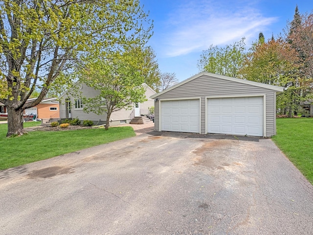 602 26th St, Scanlon, MN 55720 - view of front of home with an outdoor structure, a garage, and a front yard