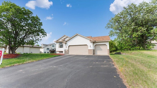 13590 Jesse St, Becker, MN 55308 - view of front of house featuring an attached garage, asphalt driveway, a front yard, and brick siding
