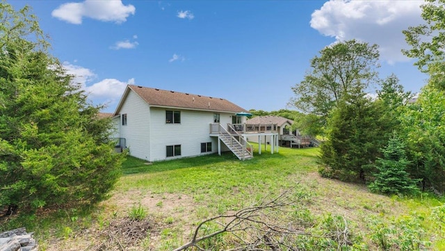 13590 Jesse St, Becker, MN 55308 - rear view of house with stairway, a wooden deck, and a yard