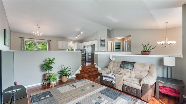 13590 Jesse St, Becker, MN 55308 - living room with a chandelier, lofted ceiling, wood finished floors, and baseboards