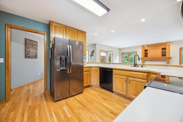 582 139th Ln NW, Andover, MN 55304 - kitchen with stainless steel fridge, black dishwasher, a sink, light wood-style floors, and stove