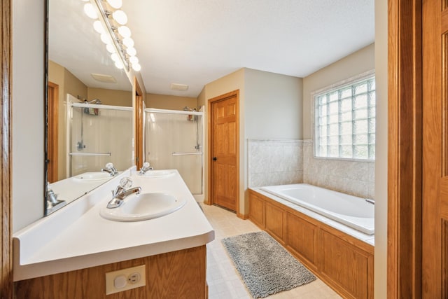 582 139th Ln NW, Andover, MN 55304 - bathroom with a stall shower, a garden tub, double vanity, and tile patterned floors