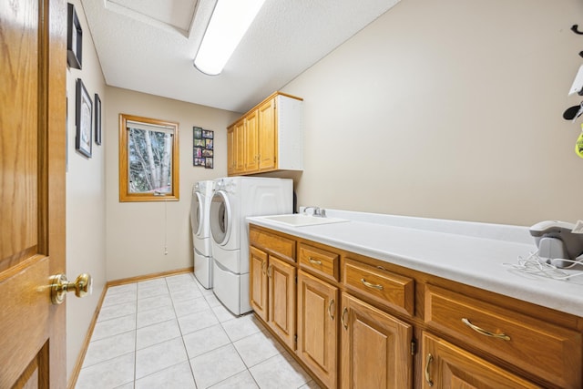 582 139th Ln NW, Andover, MN 55304 - laundry area featuring cabinet space, washer and clothes dryer, light tile patterned floors, baseboards, and a textured ceiling