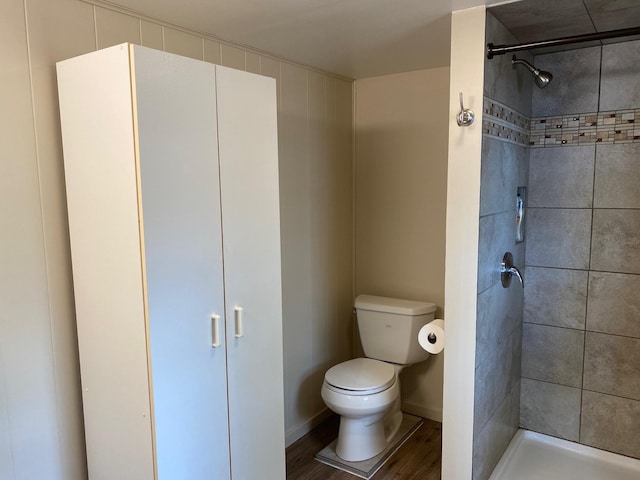 42606 Pleasure Park Rd, Otter Tail Twp, MN 56571 - full bathroom with toilet, wood finished floors, a tile shower, and baseboards