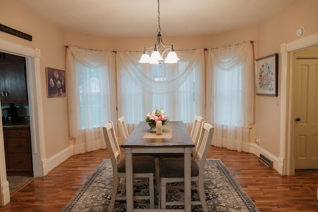 835 Park St, Fairmont, MN 56031 - dining area featuring a chandelier, wood finished floors, and baseboards