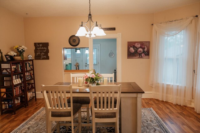 835 Park St, Fairmont, MN 56031 - dining space with a chandelier, wood finished floors, and baseboards