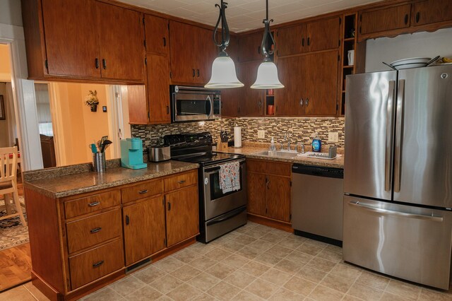 835 Park St, Fairmont, MN 56031 - kitchen with appliances with stainless steel finishes, a sink, brown cabinetry, decorative backsplash, and open shelves