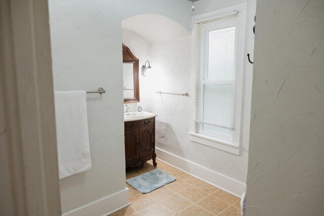 835 Park St, Fairmont, MN 56031 - bathroom featuring vanity, baseboards, and tile patterned flooring
