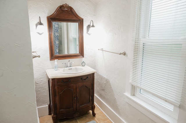 835 Park St, Fairmont, MN 56031 - bathroom featuring a textured wall, vanity, and baseboards