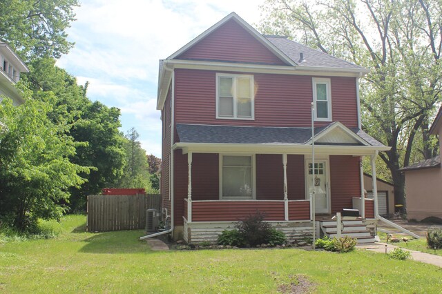 835 Park St, Fairmont, MN 56031 - traditional style home with a porch, central air condition unit, and roof with shingles