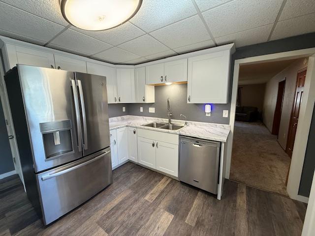 220 Front St E, Redwood Falls, MN 56283 - kitchen with appliances with stainless steel finishes, a sink, a drop ceiling, and white cabinetry