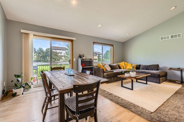 220 Maverick Ave, Elko New Market, MN 55054 - dining area featuring lofted ceiling, plenty of natural light, light wood-style floors, recessed lighting, and a textured ceiling
