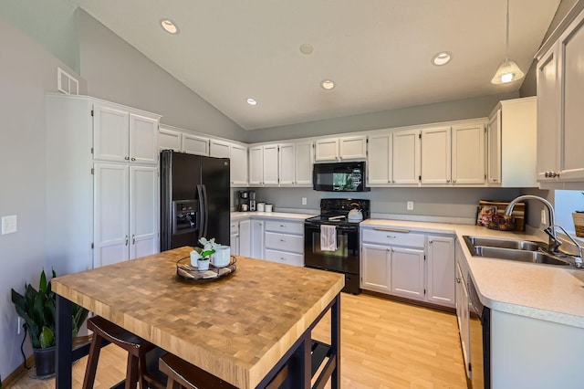 220 Maverick Ave, Elko New Market, MN 55054 - kitchen with black appliances, vaulted ceiling, light countertops, light wood-type flooring, and recessed lighting