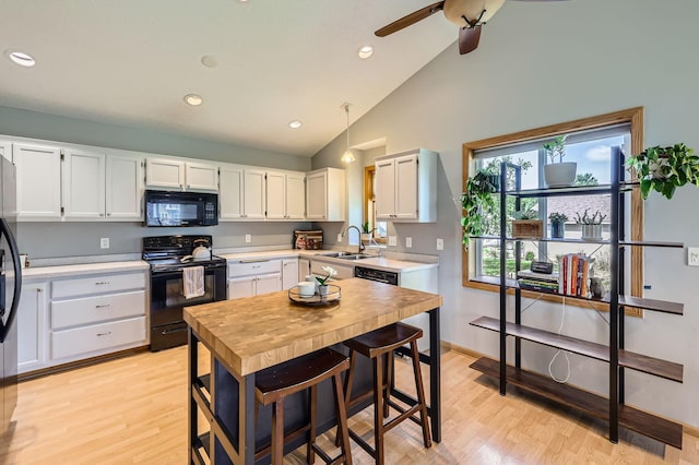 220 Maverick Ave, Elko New Market, MN 55054 - kitchen with black appliances, light countertops, white cabinets, ceiling fan, and light wood-style flooring
