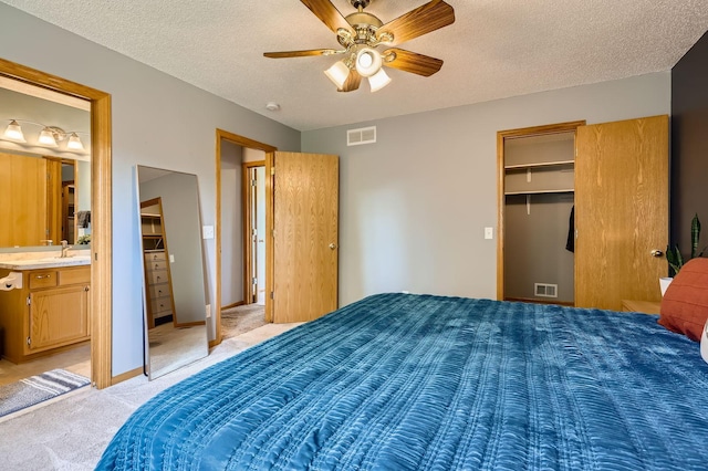 220 Maverick Ave, Elko New Market, MN 55054 - bedroom with light carpet, a textured ceiling, a walk in closet, ceiling fan, and ensuite bath
