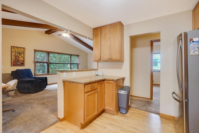 1221 43rd Ave NE, Columbia Heights, MN 55421 - kitchen featuring freestanding refrigerator, healthy amount of natural light, light stone counters, and light wood-type flooring