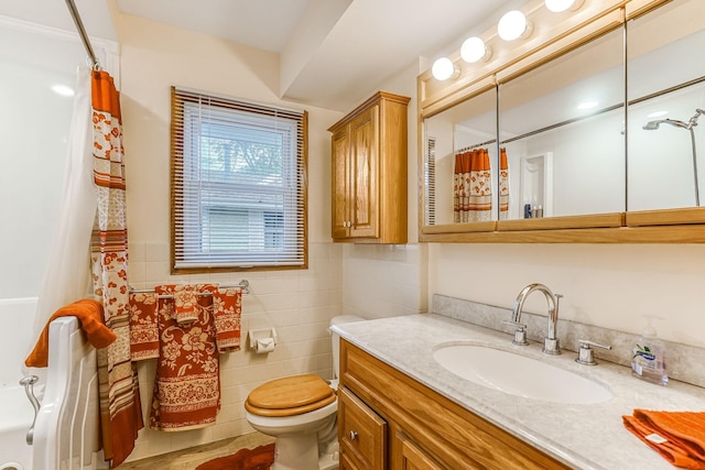 1221 43rd Ave NE, Columbia Heights, MN 55421 - full bath featuring vanity, toilet, a shower with curtain, and tile walls