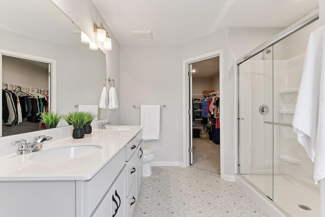 6678 Wildflower Way, Minnetrista, MN 55331 - full bathroom with double vanity, a walk in closet, a shower stall, and tile patterned floors