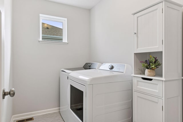 6678 Wildflower Way, Minnetrista, MN 55331 - laundry room featuring washing machine and dryer and cabinet space