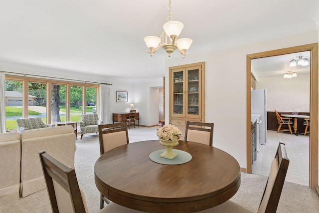 5456 Twin Lake Blvd E, Brooklyn Center, MN 55429 - dining room with a chandelier and light carpet