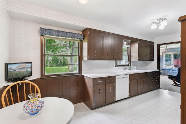 5456 Twin Lake Blvd E, Brooklyn Center, MN 55429 - kitchen featuring dishwasher, light flooring, dark brown cabinets, wallpapered walls, and wainscoting