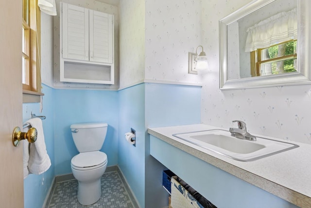 5456 Twin Lake Blvd E, Brooklyn Center, MN 55429 - half bathroom with vanity and wallpapered walls