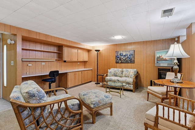 5456 Twin Lake Blvd E, Brooklyn Center, MN 55429 - living area with light colored carpet, wooden walls, and built in desk