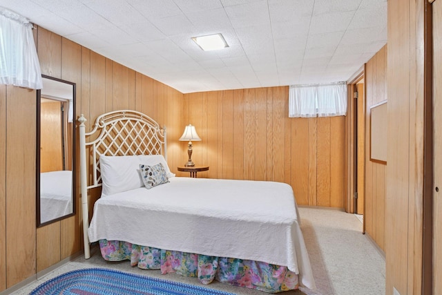 5456 Twin Lake Blvd E, Brooklyn Center, MN 55429 - bedroom featuring wooden walls and light colored carpet