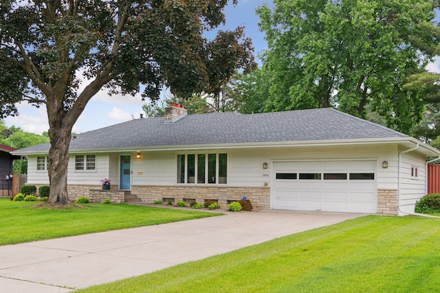 5456 Twin Lake Blvd E, Brooklyn Center, MN 55429 - ranch-style house featuring an attached garage, stone siding, concrete driveway, a front yard, and a chimney