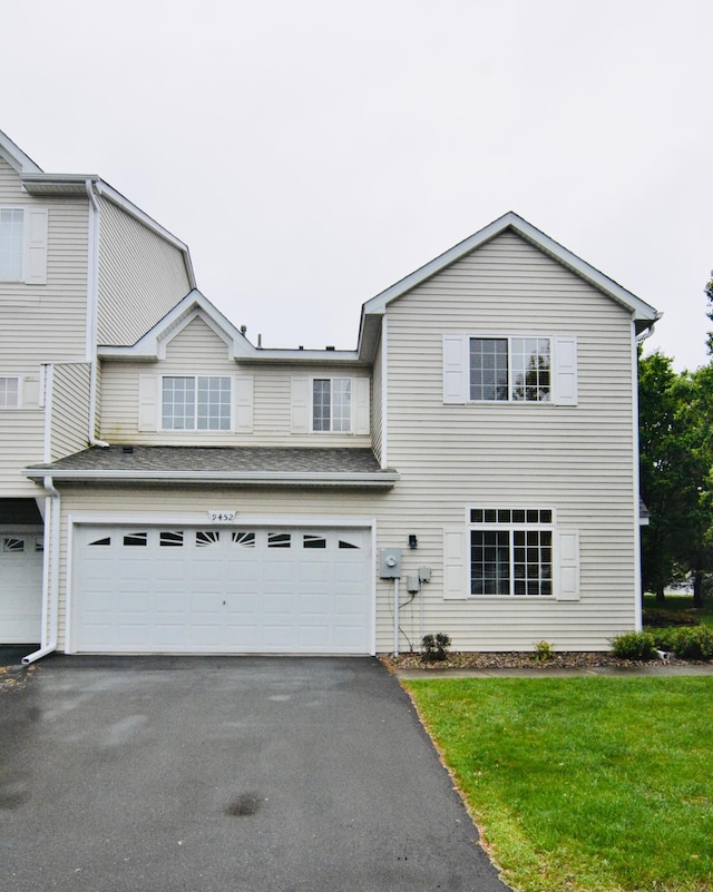 9452 Marshall Rd, Eden Prairie, MN 55347 - view of front of home featuring asphalt driveway, an attached garage, and a front lawn