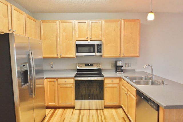 9452 Marshall Rd, Eden Prairie, MN 55347 - kitchen featuring stainless steel appliances, a sink, and light brown cabinetry