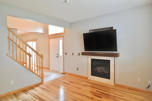 9452 Marshall Rd, Eden Prairie, MN 55347 - unfurnished living room with wood finished floors, stairs, baseboards, and a fireplace