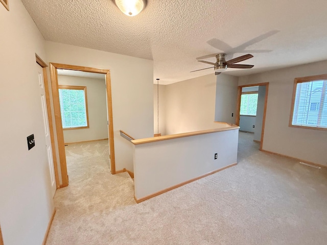 9452 Marshall Rd, Eden Prairie, MN 55347 - spare room with light carpet, baseboards, a textured ceiling, and a ceiling fan