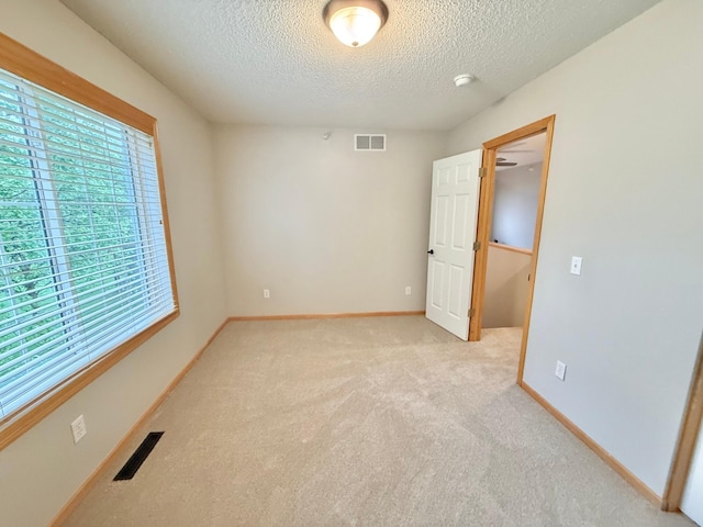 9452 Marshall Rd, Eden Prairie, MN 55347 - spare room featuring a textured ceiling, light colored carpet, and baseboards
