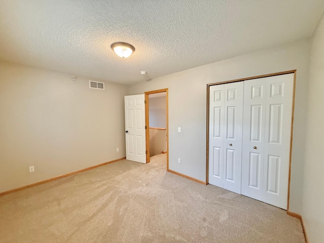9452 Marshall Rd, Eden Prairie, MN 55347 - unfurnished bedroom with light carpet, a textured ceiling, baseboards, and a closet