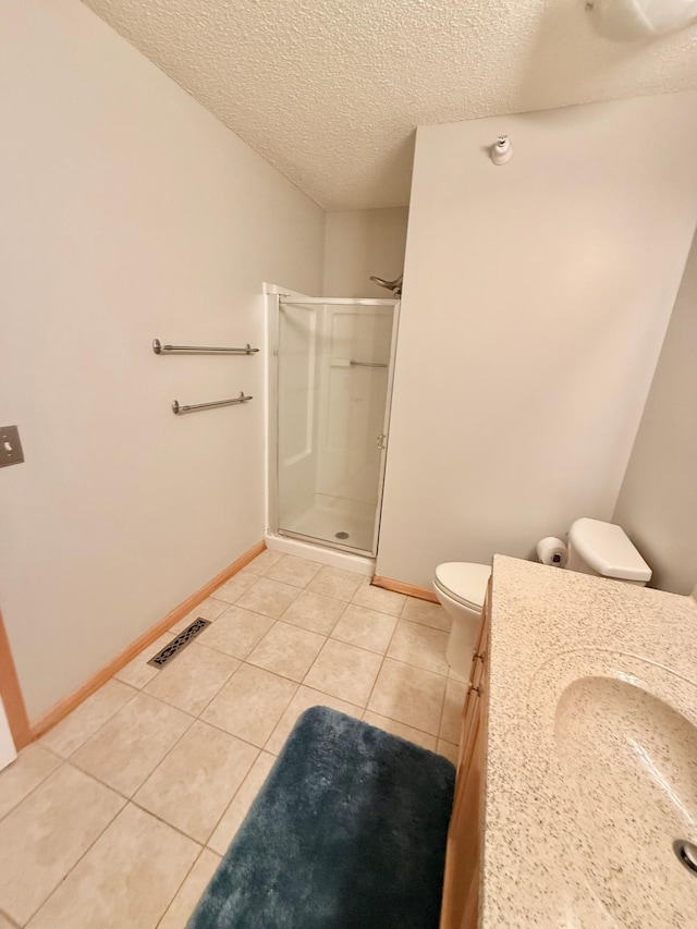 9452 Marshall Rd, Eden Prairie, MN 55347 - bathroom featuring a shower stall, a textured ceiling, vanity, toilet, and tile patterned flooring