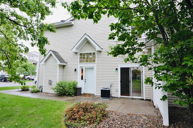 9452 Marshall Rd, Eden Prairie, MN 55347 - back of property featuring cooling unit, a yard, and a patio area