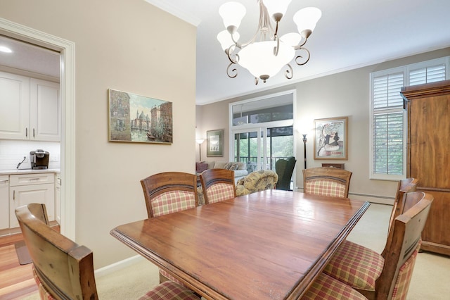 5601 Dewey Hill Rd Unit 310, Edina, MN 55439 - dining space with a chandelier, baseboard heating, crown molding, baseboards, and light carpet