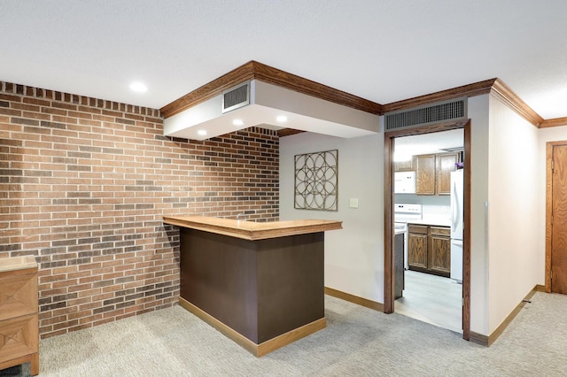 5601 Dewey Hill Rd Unit 310, Edina, MN 55439 - bar area featuring freestanding refrigerator, brick wall, light carpet, baseboards, and ornamental molding