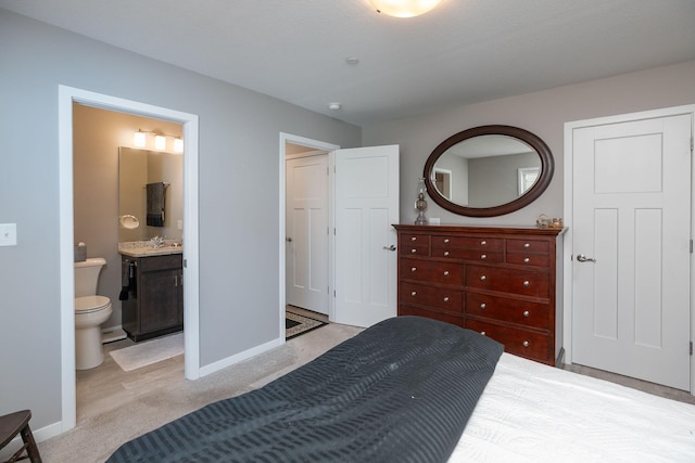 1217 Sundance Ct NE, Byron, MN 55920 - bedroom featuring baseboards, light colored carpet, and ensuite bath