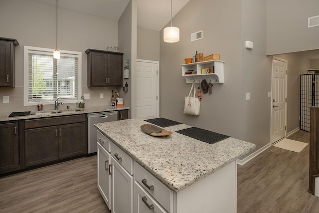 1217 Sundance Ct NE, Byron, MN 55920 - kitchen featuring a sink, stainless steel dishwasher, light wood-type flooring, dark brown cabinets, and light stone countertops