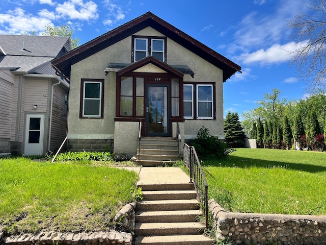 114 Webster St, Fairmont, MN 56031 - bungalow-style home featuring stucco siding and a front lawn