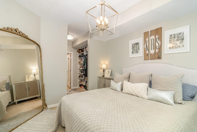 4132 Vernon Ave S Unit A101, Saint Louis Park, MN 55416 - bedroom with light carpet, a chandelier, a spacious closet, a closet, and baseboards