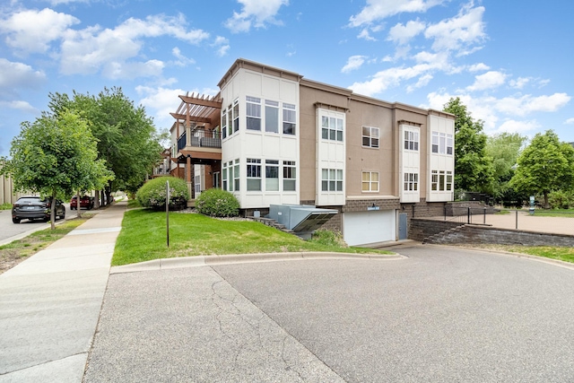 4132 Vernon Ave S Unit A101, Saint Louis Park, MN 55416 - view of property with asphalt driveway and a garage